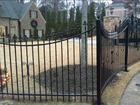 Ornamental Wrought Iron Fence with scalloped top rail, custom finials, centerpiece panels, and post toppers