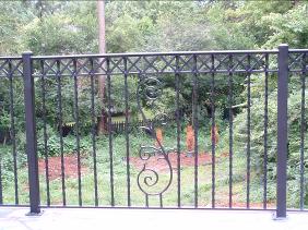 Ornamental Wrought Iron Railing with scroll centerpiece, twisted baluster pickets and "X" pattern split rail